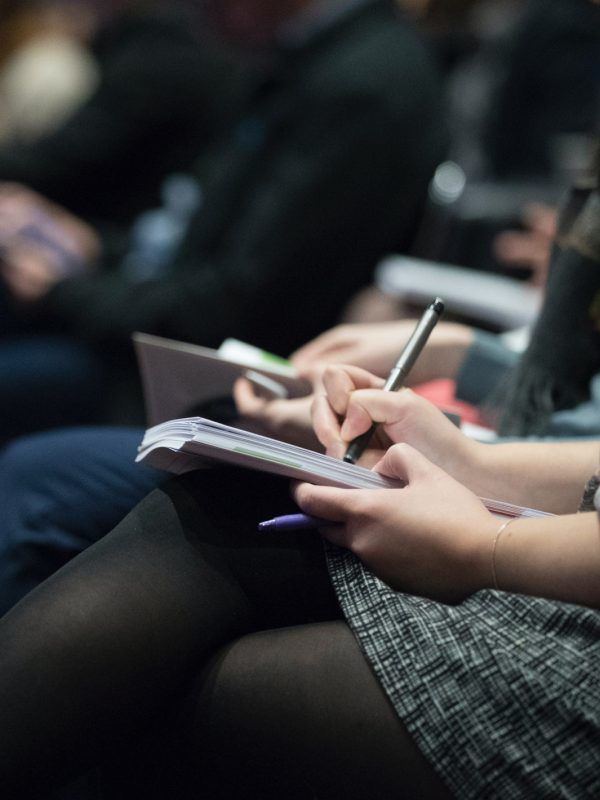 person writing in notebook